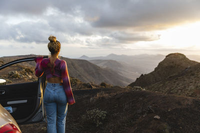 Young woman looking at mountain landscape