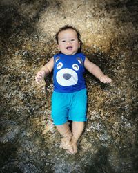 High angle portrait of boy on rock