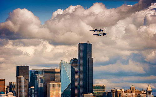 Aerial view of modern buildings in city against sky