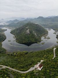 High angle view of sea and mountains against sky
