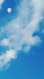 Low angle view of jellyfish against blue sky