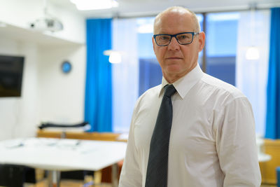 Portrait of businessman standing in office