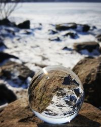 Close-up of crystal ball by sea water
