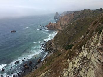 High angle view of sea and mountains against sky