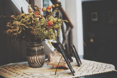 Close-up of flower vase on table at home