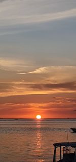 Scenic view of sea against orange sky