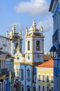 Colorful colonial houses, lanterns and  a tower of an old church in pelourinho, salvador, bahia