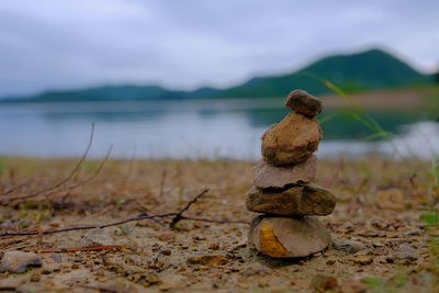 Close-up of stone stack on shore