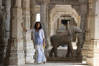 Young woman standing in front of historical building