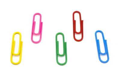 Close-up of colored pencils over white background