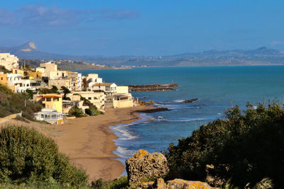 Scenic view of sea and buildings against sky