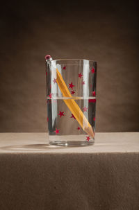 Close-up of glass container on table