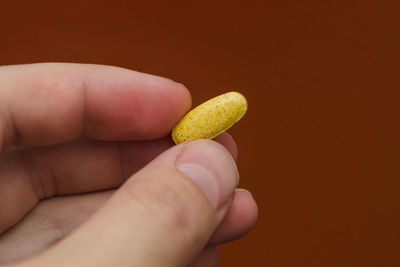 Yellow pill in hand. sports food supplements.
