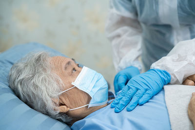 Midsection of doctor checking patient at hospital