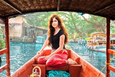 Portrait of young woman on boat in lake