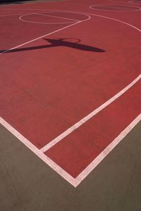 Basketball hoop shadow silhouette on the court on the street