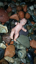 High angle view of hands on rocks