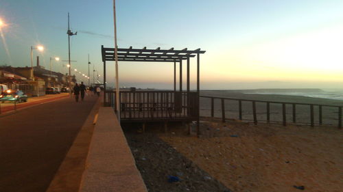 Pier on sea at sunset