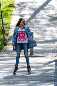 Full length of woman standing on road