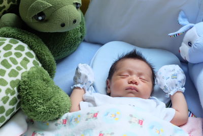 Close-up of cute baby sleeping in bed