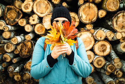 Full length of man holding logs