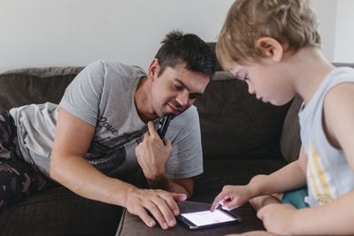 Father with son using cell phone