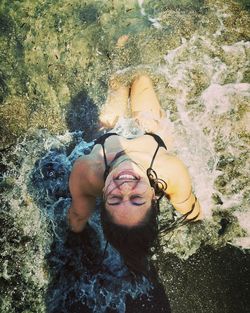 High angle portrait of a woman lying on beach