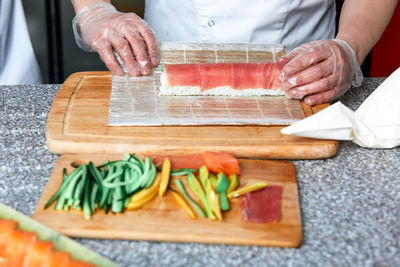 Midsection of man preparing food on table