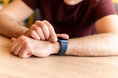 Male hand with a wrist smart apple watch. young man people using modern technology