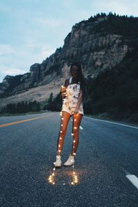 Woman standing on road