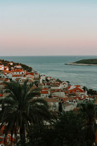 Scenic view of sea and buildings against sky