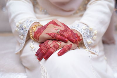 Midsection of bride with henna tattoo