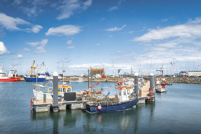Small fishing boats moored in howth harbour, dublin, ireland