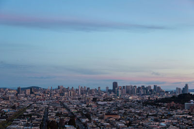 Cityscape against cloudy sky