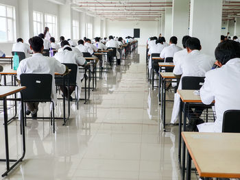 Rear view of people sitting on table