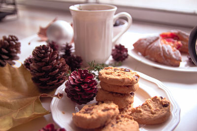 High angle view of cookies and christmas decorations on table