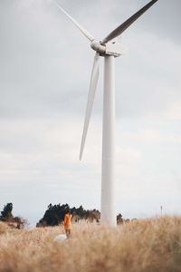 Windmill on field against sky