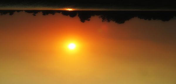 Scenic view of calm sea at sunset