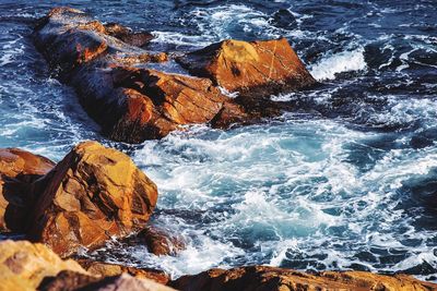 High angle view of rocks in sea