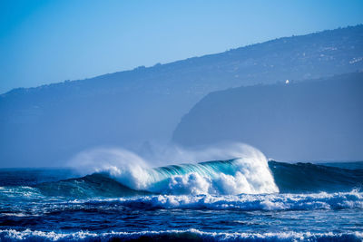 Scenic view of sea against clear blue sky