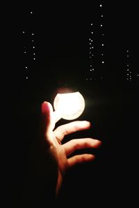 Close-up of hand holding illuminated light