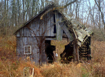 Abandoned barn in field