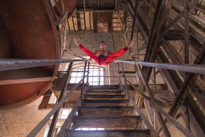 Low angle view of woman standing on staircase