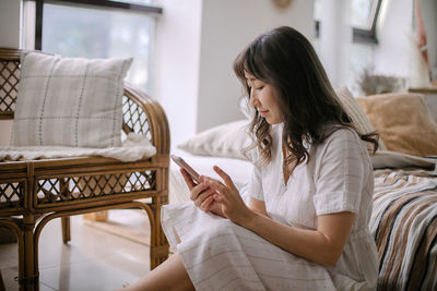 Woman sitting on seat at home