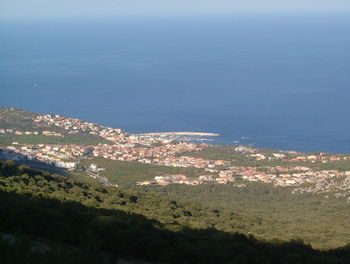 High angle view of landscape and sea against sky