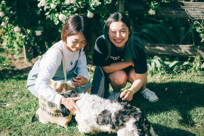 Happy girl with dog and woman