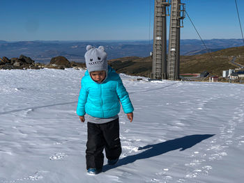 Little boy in the snow of the mountains of sierra nevada