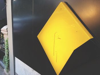 High angle view of yellow sign on wall