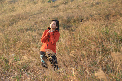 Young woman looking away on field