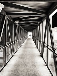 Rear view of people walking on footbridge